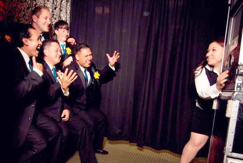 Groom, best man, and party at photo booth